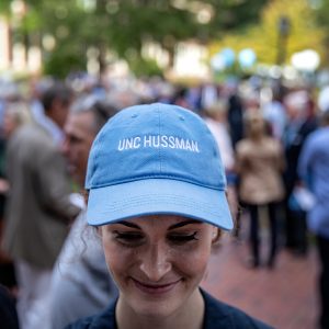 Student wearing light blue hat that reads UNC Hussman