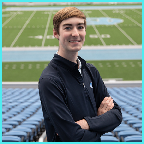 Carolina student Lucas Boyle stands with crossed arms in the stands of Kenan Stadium