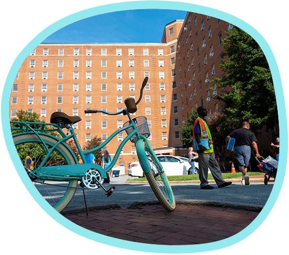 Hinton James Residence Hall in the background with a teal bike in the foreground